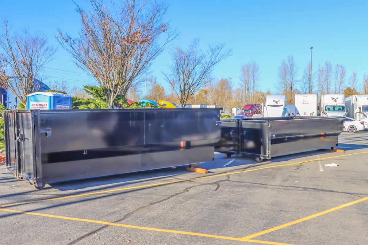Professional dumpster rental service with roll-off container on residential driveway in Coppell